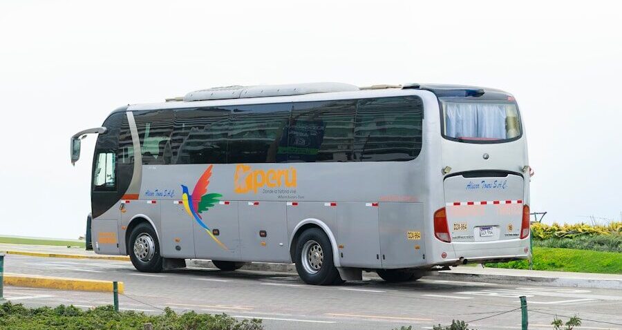A gray tour bus parked on a road.